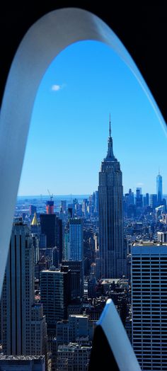 a view from the top of a building looking down at skyscrapers and other tall buildings