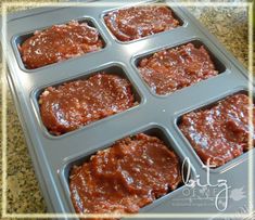 cupcakes with chocolate frosting in a muffin tin