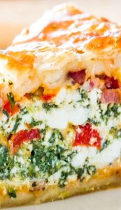 a slice of quiche with spinach and cheese