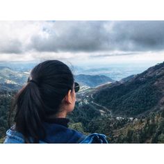 a woman looking out over the valley below