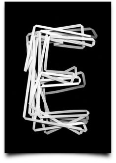 the letter e is made up of white plastic strips on a black background with clippings