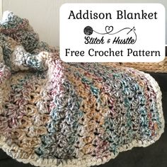 a crocheted blanket sitting on top of a couch next to a wicker basket