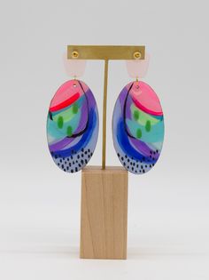 Turn heads, and make hearts flutter with these carefully crafted hand painted earrings. These multi-color beauties shimmer and shine with a resin finish and iridescent details. Plus, the gold accents and gold finished hardware add a luxe touch. Eye-catching and unique, these earrings make a fun statement! Colors will vary on different screens. Most appear brighter in person. Abstract Ideas, Heart Flutter, Painted Resin, Hand Painted Earrings, Painted Earrings, Shimmer And Shine, Jewelry Candles, Shimmer N Shine, Holiday Stickers