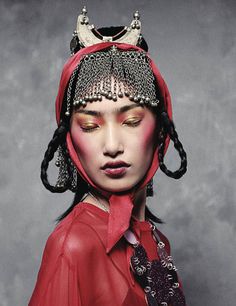 a woman with red makeup and horns on her head