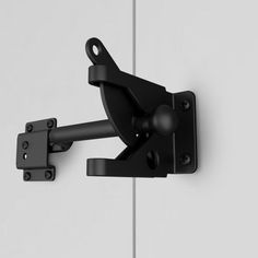 an image of a black door handle on the side of a white door with metal latch