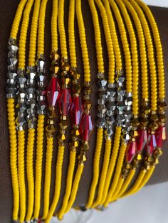 This meticulously handcrafted waist bead is designed to illuminate your silhouette with the cheerful glow of sunshine. Immerse yourself in the inviting warmth and lively charm of this waist bead, created to bring a touch of positivity and vibrancy to your style. ☀️ Yellow Glass Seed Beads - Radiant Joy: This waist bead is adorned with yellow glass seed beads, symbolizing radiant joy and positivity. Yellow is a color associated with energy and happiness, bringing a sunlit warmth to the waist bead Red Beaded Bracelets For Festivals, Red Round Beaded Bracelets For Festivals, Yellow Beaded Bracelets For Festival, Handmade Yellow Beaded Bracelets For Festivals, Yellow Bohemian Bracelets For Festive Occasions, Bohemian Waist Beads As Gift, Bohemian Yellow Bracelets For Festive Occasions, Adjustable Beaded Waist Beads As Gift, Yellow Beaded Bracelets With Round Beads For Festival