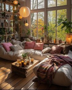 a living room filled with lots of furniture next to a large window covered in plants