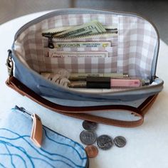 a purse filled with lots of money sitting on top of a table