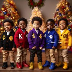 five children standing in front of a christmas tree wearing sweaters and pants with letters on them