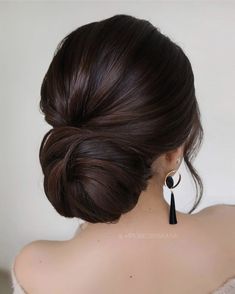 a woman with her hair in a low bun