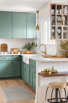 a kitchen with green cabinets and white counter tops