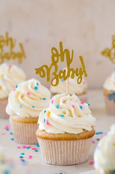 cupcakes with white frosting and gold sparklers