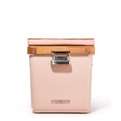 an old pink ice chest with wooden lid and handle on white backgrounnd