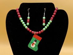 Metal snowman Christmas stocking necklace and earring set.  This will make any holiday outfit festive!  Optional matching bracelet available.  Each piece has a custom length to fit all sizes.  Necklace is made from glass pearls and crystals to form a unique and stylish look.  I can convert any of the earrings from pierced to clip on style at no charge, please request this in notes with purchase.  Please do not hesitate to contact me with any questions, I would love to hear from you. Pendant Size Multicolor Christmas Jewelry Gift, Multicolor Jewelry Christmas Gift, Green Christmas Jewelry For Festive Occasion, Green Festive Jewelry For New Year, Handmade Holiday Jewelry, Metal Snowman, Set Plus Size, Matching Bracelet, Holiday Outfit