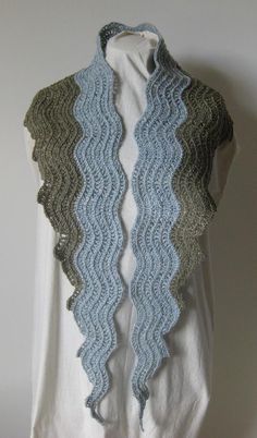 a white shirt with blue and green crochet on it