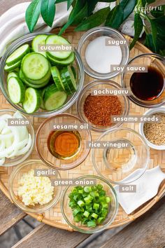 the ingredients to make cucumber soup are arranged in bowls on a bamboo tray