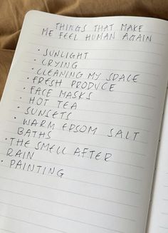 an open notebook with writing on it that says things that make me feel human again