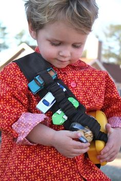 a little boy that is holding a toy