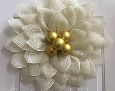 a white door with a gold flower on it