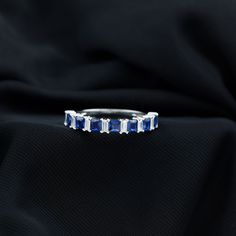 Product Details Make an impressive statement with this enchanting Half Eternity Ring, featuring Princess Cut Lab Created Blue Sapphires and Baguette Cut Diamond securely set in a prong setting. This Semi Eternity Ring exudes luxury and elegance, making it the perfect accessory to enhance your overall look. Add charm and allure to your appearance with this Lab Created Blue Sapphire Eternity Ring, a timeless piece that complements your style with grace and sophistication. Product Information SKU S Princess Cut Sapphire Ring In Fine Jewelry Style, Fine Jewelry Sapphire Princess Cut, Princess Cut Sapphire Ring Fine Jewelry, Princess Cut Rings With Center Lab-created Sapphire, Blue Princess Cut Lab-created Sapphire Rings, Sapphire Eternity Ring, Half Eternity Ring, Baguette Cut Diamond, 18k Yellow Gold Ring