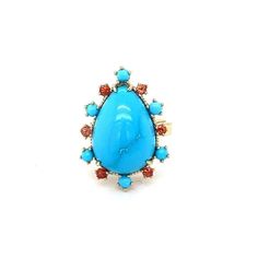 This ring has a 9.67 Carat Pear Cut Turquoise and is surrounded by 6 Round Cut Orange Sapphires that weigh 0.38 Carats and 6 Turquoise stones that weigh 0.52 Carats. The total carat weight of the ring is 10.57 Carats. The ring is crafted in 14 Karat Yellow Gold and weighs 7.7 grams. The ring is a size 7  The Turquoise are natural and mined in Persia. This Turquoise has some natural visible inclusions that gives this piece a very authentic and antique type look.  Exact dimensions for this item ar Turquoise Oval Multi-stone Opal Ring, Turquoise Multi-stone Ring Fine Jewelry, Fine Jewelry Turquoise Multi-stone Ring, Turquoise Rings With Gemstone Accents In Fine Jewelry Style, Turquoise Ring With Gemstone Accents Fine Jewelry, Luxury Blue Multi-stone Turquoise Ring, Turquoise Fine Jewelry Ring With Gemstone Accents, Fine Jewelry Blue Turquoise Cabochon Ring, Oval Blue Multi-stone Turquoise Ring