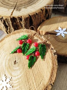 two pieces of wood with holly and red berries on them