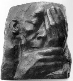 a black and white photo of a statue holding his hands to his face with both hands