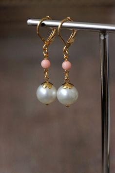 Elegant everyday earrings with high quality white pearl coated crystal 10 mm beads (made in Austria), delicate pink coral paste stone 4 mm beads, gold tone flower shape bead caps and gold tone stainless steel lever back earring hooks. Earring hooks are from lead free & nickel free metal. Perfect for everyday wear or a great gift for someone special! *The total lenght of earrings is about 43 mm including earring hooks. Other earrings of my shop you can see here: https://www.etsy.com/shop/NaTavell Gold Earrings With Pearl Drop And Round Beads, Gold Earrings With Pearl Drop, Elegant Gold Beaded Earrings With Lever Back, Elegant Beaded Drop Earrings With Lever Back, Pearl Dangle Earrings With Lever Back, Pearl Earrings Gold, White Pearl Earrings, Earrings White Gold, Crystal Pearl Earrings