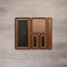 four wooden trays with black leather covers