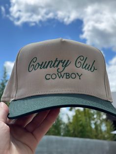 Calling all cowgirls! Elevate your style with our Country Club Cowboy Trucker Hat. Featuring an embroidered western graphic, this trendy hat is the perfect accessory to complete any casual outfit. Perfect for spring and summer, wear it to concerts and festivals for a chic and fashionable look. Available in 2 colors! Twill cap Made in USA Embroidery at front and side panel Adjustable back strap Brim measures approx 3" in lengthOS measures approx 23.55" in circumference Vintage Rodeo Baseball Cap With Curved Brim, Western Flat Brim Baseball Cap For Rodeo, Vintage Curved Brim Baseball Cap For Rodeo, Western Style Baseball Cap With Curved Brim For Rodeo, Western Style Snapback Baseball Cap For Country Events, Western Style Curved Brim Baseball Cap For Rodeo, Country Style Flat Brim Baseball Cap For Rodeo, Retro Spring Baseball Cap For Outdoor, Retro Snapback Hat For Outdoor Use In Spring