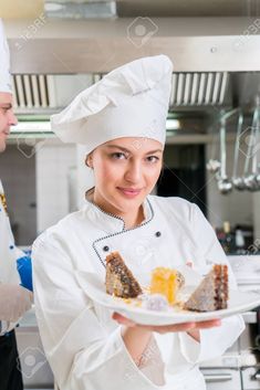 a woman chef holding a plate with desserts on it