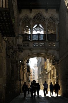 several people walking down an alley way in the city