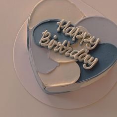 a heart shaped birthday cake with the words happy birthday on it's frosting