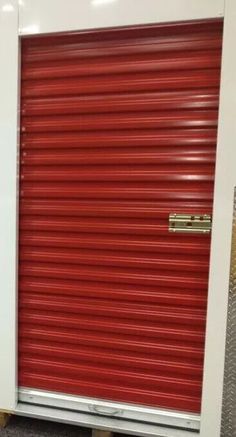 a red and white storage unit in a warehouse or office building with the doors closed