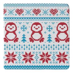 a knitted christmas sweater with penguins and snowflakes in red, white and blue