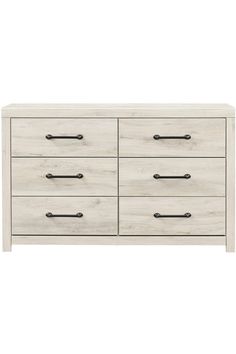 a white dresser with black handles and drawers