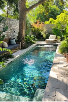 an outdoor swimming pool surrounded by greenery