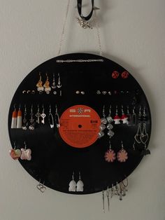 a record with earrings hanging from it