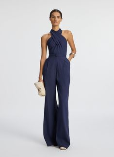 Front view of woman wearing navy blue sleeveless jumpsuit Blue Jumpsuits Outfit, Semi Formal Wedding Attire, Jumpsuit Outfit Wedding, Cocktail Wedding Attire, Raffia Clutch, Semi Formal Attire, Jumpsuit Navy Blue