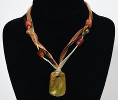 "A beautiful necklace made up of three separate fabric ribbons set with red coral beads, carnelian beads, citrine beads, and a yellow jade pendant. 16 1/2\" long with a 2 1/2\" extension chain Yellow jade pendant is 1 1/2 x 1\"" Ribbon Necklaces, Necklaces Ideas, Yellow Jade, Coral Pendant, Citrine Beads, Ribbon Necklace, Blue Stone Ring, Gold Bead Necklace, Carnelian Beads