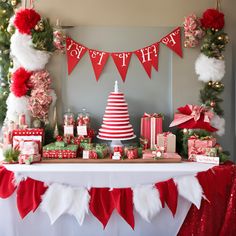 a table topped with lots of presents under a christmas tree