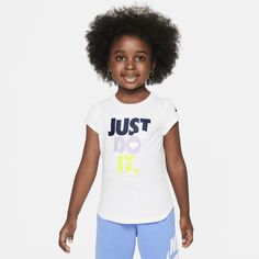 Put your child in the Sweet Swoosh life with this tee, which is made of smooth cotton/poly jersey with a regular fit they can move freely in and the tagless crewneck provides a comfy feel. Nike T-shirt With Text Print For Sports, Playful Crew Neck T-shirt With Logo Print, Playful Nike Crew Neck T-shirt, Playful Sports Tops With Letter Print, Playful Graphic Print Sports Tops, Nike Cotton T-shirt In Playful Style, Playful Nike Crew Neck Top, Playful Nike Tops For Sports, Playful Nike Short Sleeve Tops