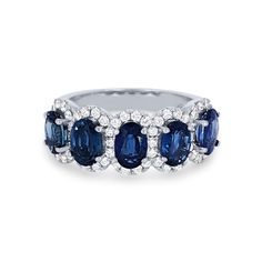 a ring with blue and white stones on it, set in 18k white gold