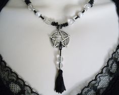 "This lovely necklace has clear faceted beads, glass pearl beads, black obsidian nugget beads, seed beads, pewter silver accent beads, silver plated bead caps and a pewter silver pentacle with beaded silk tassel. 18\" long. Toggle clasp." Mystical Halloween Festival Necklaces, Mystical Necklaces For Halloween, Gothic Dangle Necklaces For Jewelry Making, Mystical Halloween Festival Necklace, Spiritual Halloween Festival Necklaces, Spiritual Necklaces For Halloween Festival, Spiritual Necklace For Halloween Festival, Adjustable Gothic Pendant Necklace, Mystical Adjustable Halloween Jewelry