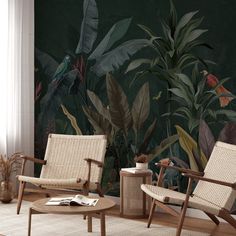 two chairs and a coffee table in front of a wall with tropical plants on it