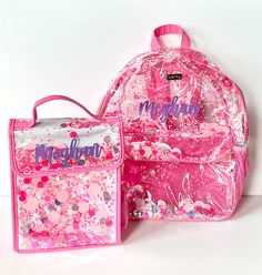 Get ready to party in pink with this vinyl backpack designed with someone on-the-go in mind! Packed with our Pink Party confetti, this is a can't miss whether you're headed back to school or looking for a way to brighten your travel days or commute. This heavy-duty backpack comes with adjustable straps, side pockets to hold a water bottle or other accessories, a front pocket, and with luxe gold hardware too - what's not to love? This backpack is available in Medium and Large sizes. And what's even better is adding the matching lunchbox! {SPECIFICATIONS} CONFETTI BACKPACK (LARGE SIZE) Dimensions: 14"W x 6.5"D x 18"H (MEDIUM SIZE)   Dimensions: 11"W x 5.5"D x 16"H Clear vinyl with Pink Party trapped confetti backpack with front pocket 2 exterior pink mesh pockets for a water bottle Pink nylo Trendy Pink Bag For School Events, Trendy Pink Bags For School Events, Playful Pink Party Bag, Fun Pink Backpack For Back To School, Pink Fun Backpack For Back To School, Pink Backpack For End Of School Year Gift, Pink Backpack Gift For End Of School Year, Rectangular Pink Bag For School Events, Rectangular Pink School Event Bag