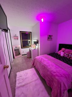 a bed room with a neatly made bed and purple lighting