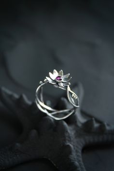 ITEM DESCRIPTION: The size of ring 6 3/4 (US and Canada) N 1/2 (UK and AU) I can make it any size you want - just mark your size in the order And you can order this lotus ring with another gemstone - please write to me before order. Weight - 2 g. Lotus flower ring was made by me of sterling silver and natural rhodolite garnet. It looks so transparent and light, like a piece of elver jewelry. The floral ring will be a great addition to your jewelry collection or a special piece for Engagement. Oo Silver Flower Jewelry For Proposal, Nature-inspired Flower Wedding Rings, Flower Shaped Proposal Ring, Silver Flower Ring For Proposal, Handmade Delicate Flower Ring For Wedding, Delicate Handmade Flower Ring For Wedding, Sterling Silver Flower Ring For Wedding, Handmade Unique Flower Promise Ring, Nature-inspired Flower Promise Ring