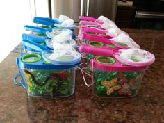 several plastic containers filled with green and purple food on top of a granite countertop