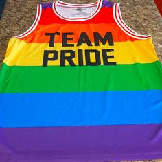 It's Brand New Without Tags. Multicolor Letter Print Tops For Pride, Multicolor Cotton Tops For Sports Events, Fun Multicolor Tops For Pride, Fun Multicolor Pride Tops, Casual Multicolor Tops For Pride, Sleeveless Tops With Letter Print For Team Events, Multicolor Cotton Tops For Pride, Rainbow Print Tops For Pride, Multicolor Team Spirit Tops With Letter Print